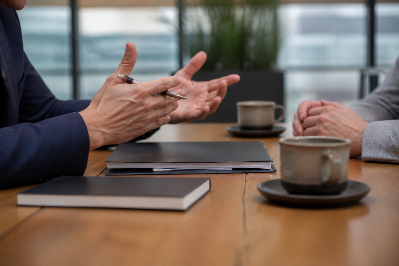 Close-up of an executive coaching plan review across a conference table